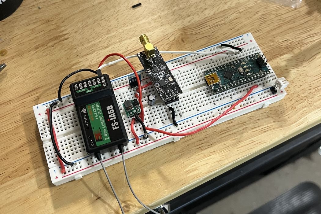 Relay electronics on the bench: FS-iA6B receiver, nRF24L01+ transceiver, and Arduino Nano on the breadboard.